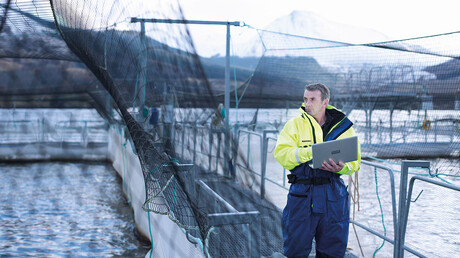 Service technician checking a compressed air system used in aquaculture.